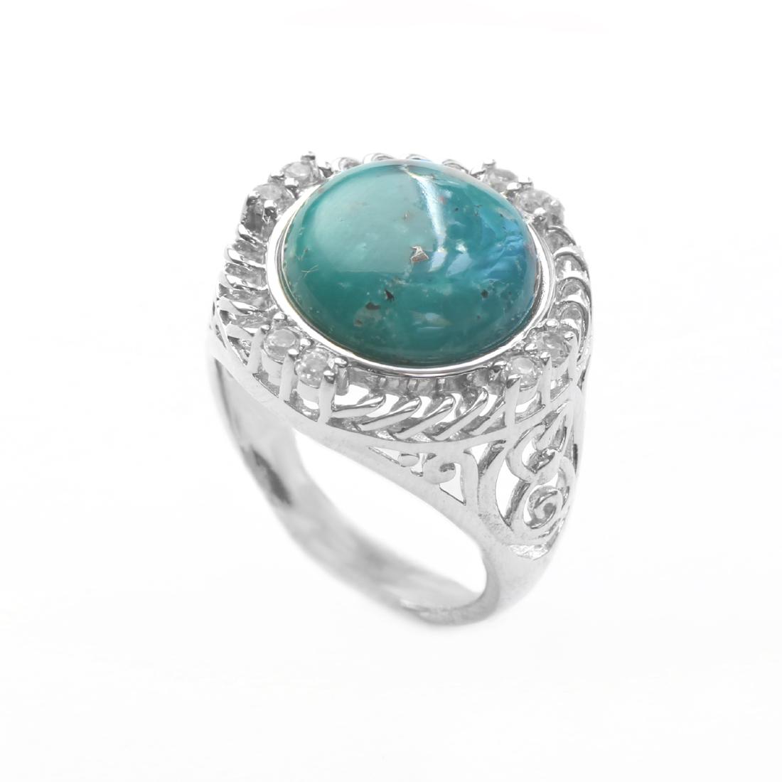 Silver Turquoise & White Topaz Textured Ring-SZ 7: One round alluring genuine campo frio turquoise cabochon is artfully crowned wtih mesmerizing spirals of sterling silver. Pairs of shimmering white topaz mark the cardinal points and open scrollwork s