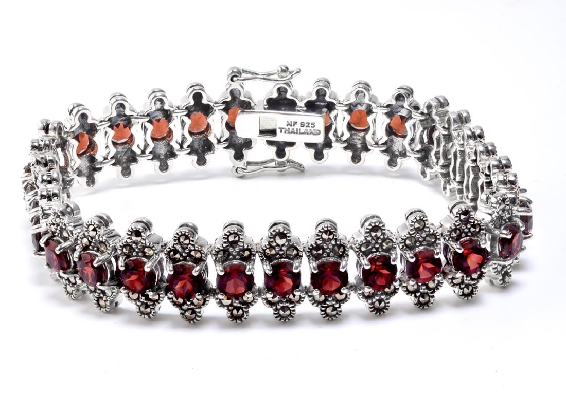 Silver 7.5" Garnet & Marcasite Line Bracelet: This lovely slender bracelet from the Pangea Mines Treasured Gems Collection is beautifully crafted in fine sterling silver and adorned with sparkling genuine Mozambique garnet accented by marcasite. 