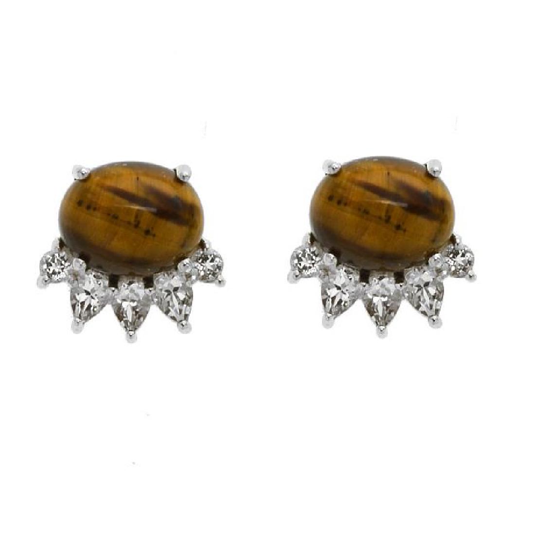 Sterling Silver Tiger Eye & Topaz Stud Earrings: • Genuine white topaz & tiger's eye • 1.24ct white topaz • One oval gemstones with shimmering white topaz arc over like a crown design • Comfortable butterfly clasp • Gle