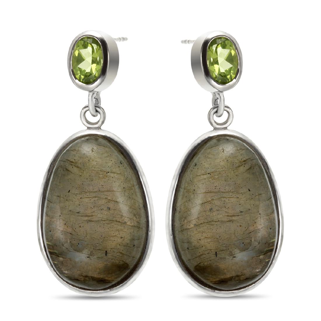 Sterling Silver Labradorite & Peridot Drop Earring: Crafted in rhodium over sterling silver, each earring in this charming pair features one large oval labradorite cabochon at the center of the dangle. One oval cut faceted peridot decorates the post an