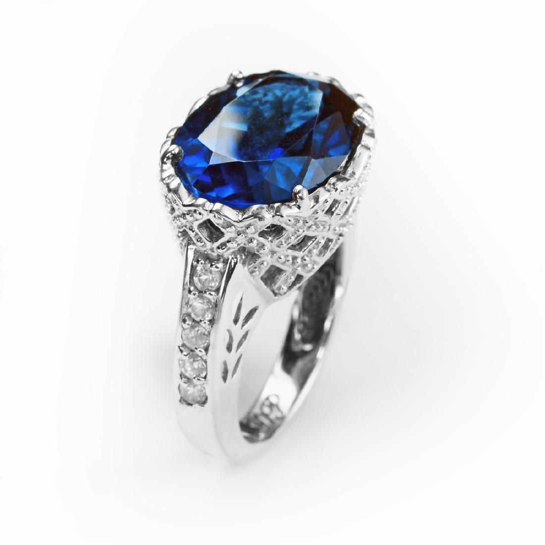 Silver 11.24ctw London Blue Topaz Ring-SZ 7: • Genuine london blue topaz & white zircon • 10.91ct london blue topaz & 0.33ct white zircon • London blue measure 16x12mm oval faceted cut • A basket weave setting with beaded