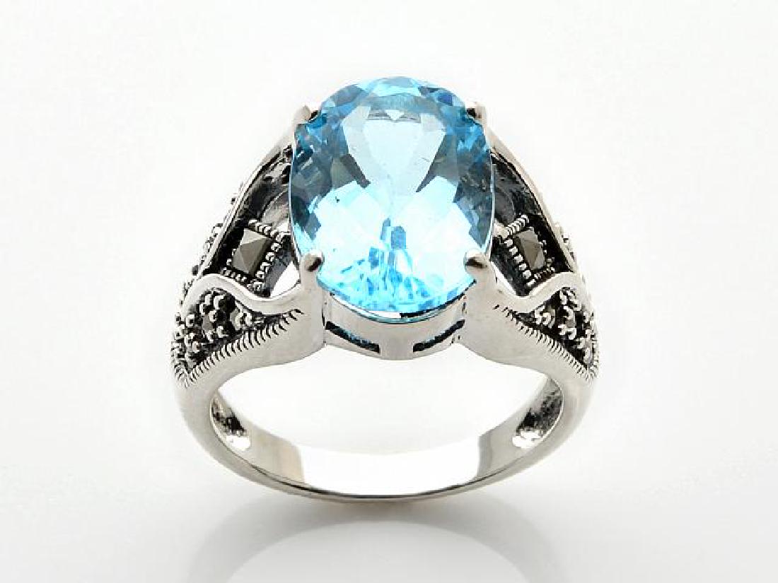Silver Oval Sky Blue Topaz & Marcasite Ring-SZ 6: • Genuine sky blue topaz & marcasite • One oval faceted cut 14x10mm blue topaz • Gleaming rhodium over fine sterling silver • Topaz is the birthstone for the month of December.