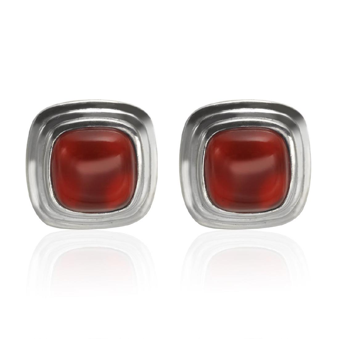 Sterling Silver 9mm Carnelian Stud Earrings: Each sterling silver earring in this simply stated pair features one Carnellian cushion shaped gemstone at the center. A three tiered cushion shaped setting surrounds the stone and supports the post. 