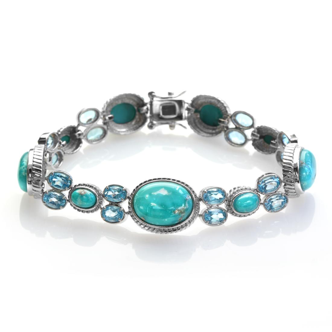 Silver 8.2" Turquoise & Swiss Blue Topaz Bracelet: Pangea Mines Treasured Gems Collection Genuine sparkling swiss blue topaz and campo frio turquoise gemstones adorn this lovely design from the Pangea Mines Treasured Gems Collection. Crafted in gleami