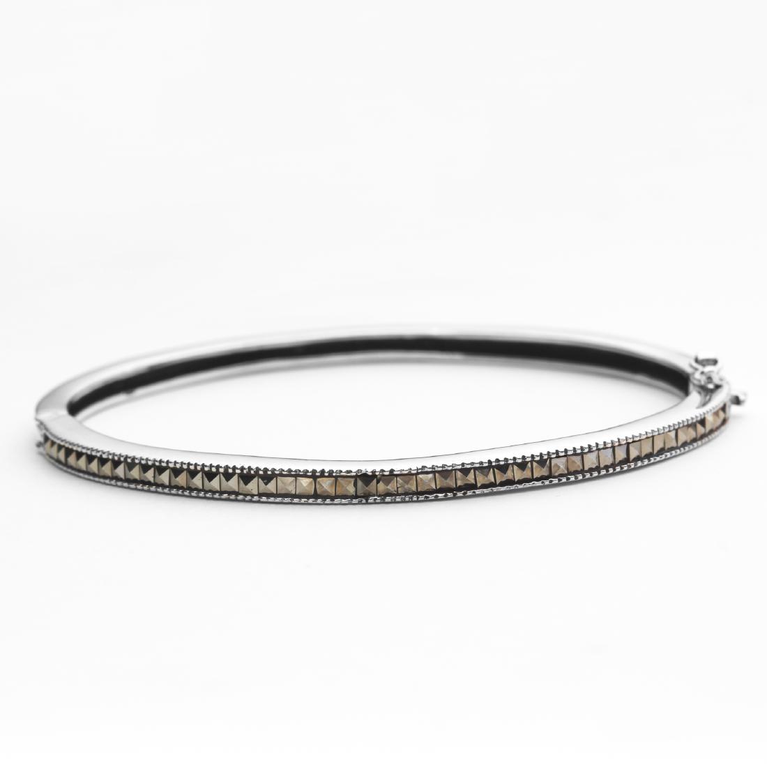 Sterling Silver 7.5" Marcasite Bangle: Addison Lane crafts a lovely bangle from the Weekend Collection. Gleaming sterling silver is adorned with genuine marcasite and styled with a convenient slide insert clasp. The lovely slender design d