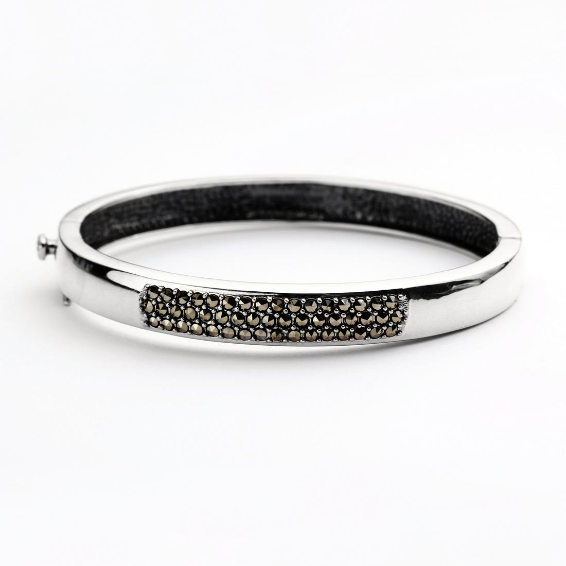 Sterling Silver Marcasite Pave Bangle 7.5": • Genuine marcasite • Stones in pave settings • Slide insert clasp for secure fit • 7.5 inch length • Gleamingrhodium over Fine sterling silver
