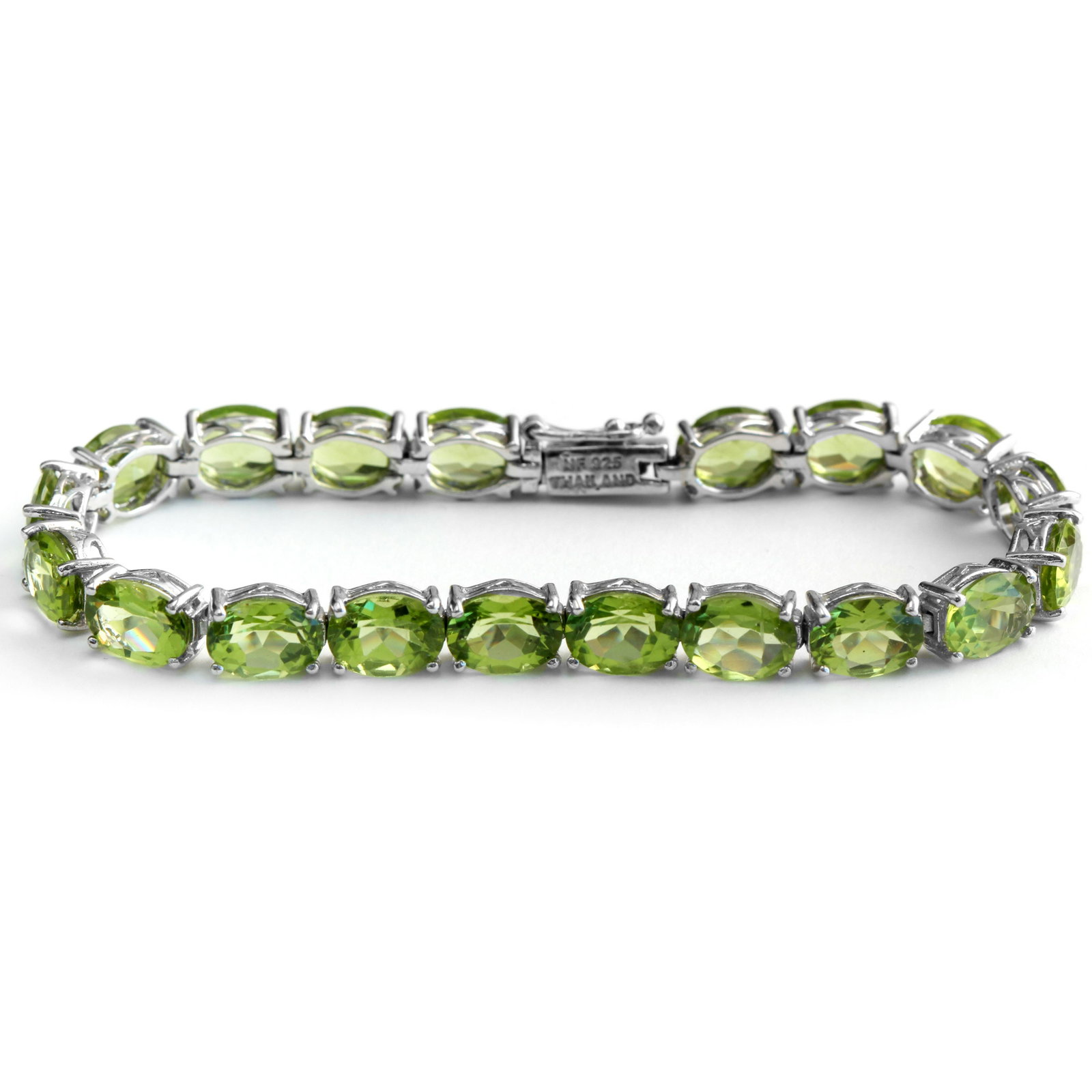 Sterling Silver 20.90ctw Peridot Tennis Bracelet: Flatter your wrist with this lovely ultra-slender bracelet from the Pangea Mines Treasured Gems Collection. Beautifully crafted in fine sterling silver and lavishly adorned with genuine peridot, this 