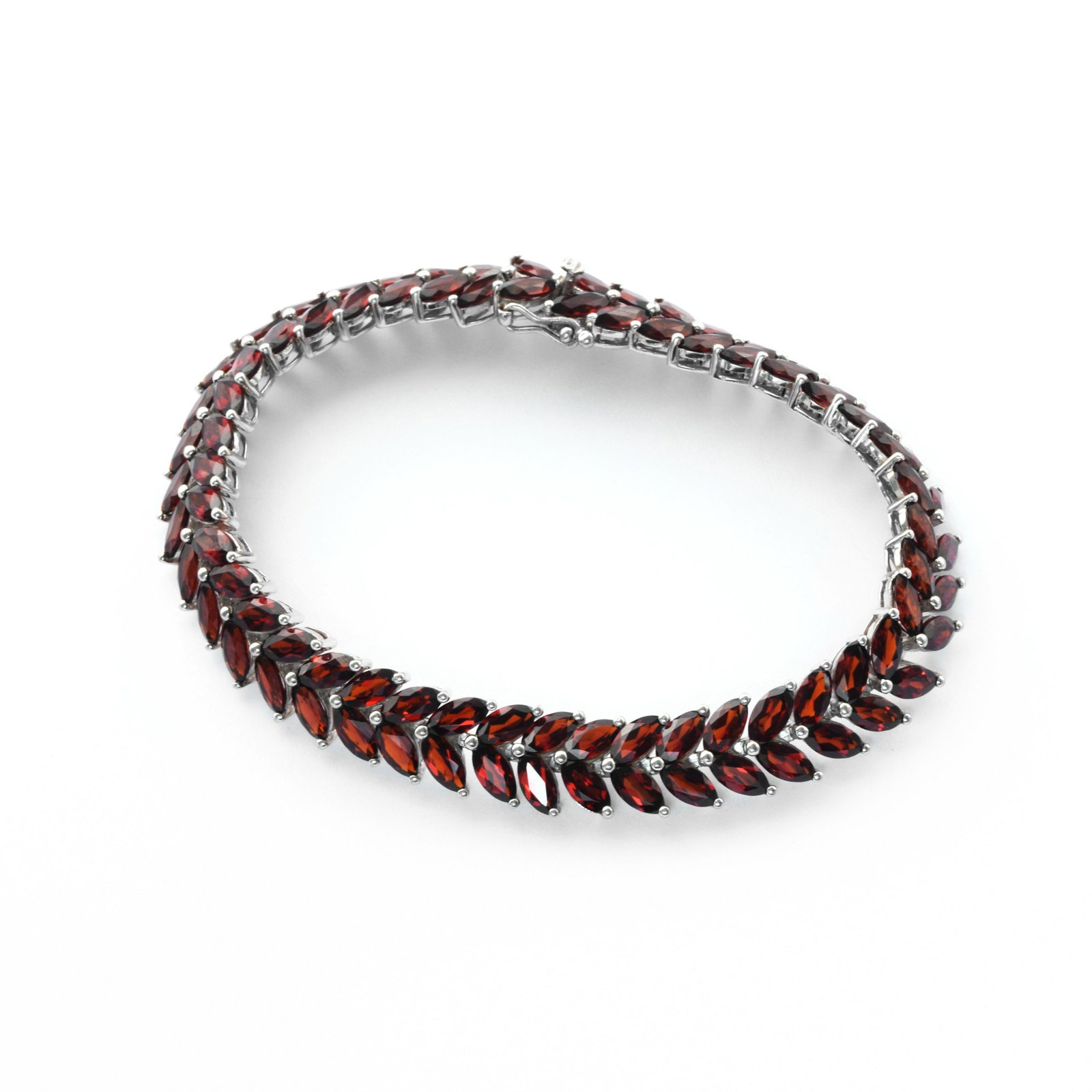 Silver 20.0ct Marquise Perdiot Line Bracelet 7.5": • Genuine mozambique garnet • Rows of marquise shaped garnet • 7.5 inch length • Slide & insert clasp • Gleaming rhodium over fine sterling silver