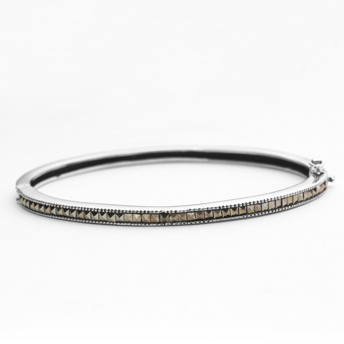 Sterling Silver Marcasite Bangle 7.5": Addison Lane crafts a lovely bangle from the Weekend Collection. Gleaming sterling silver is adorned with genuine marcasite and styled with a convenient slide insert clasp. The lovely slender design d