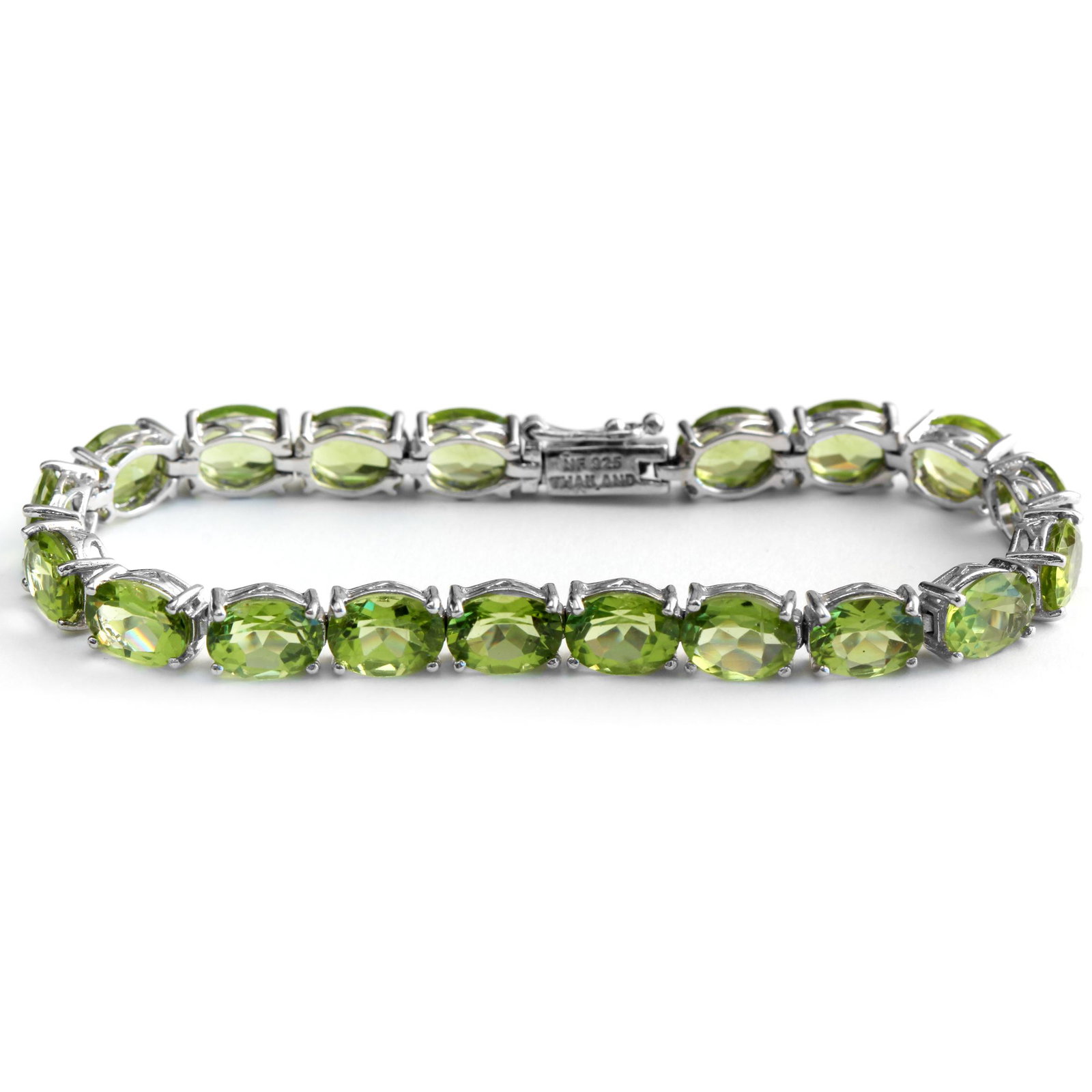Sterling Silver 24.20ctw Peridot Tennis Bracelet: Flatter your wrist with this lovely ultra-slender bracelet from the Pangea Mines Treasured Gems Collection. Beautifully crafted in fine sterling silver and lavishly adorned with genuine peridot, this 