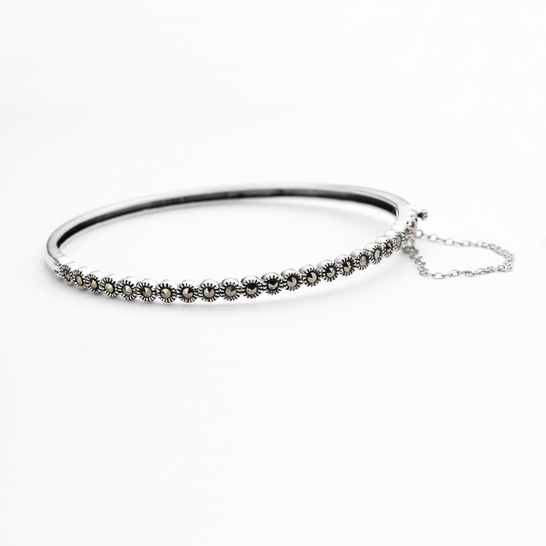 Sterling Silver Marcasite Bangle 7.5": Addison Lane crafts a lovely bangle from the Weekend Collection. Gleaming sterling silver is adorned with genuine marcasite and styled with a convenient slide insert clasp. The lovely slender design d