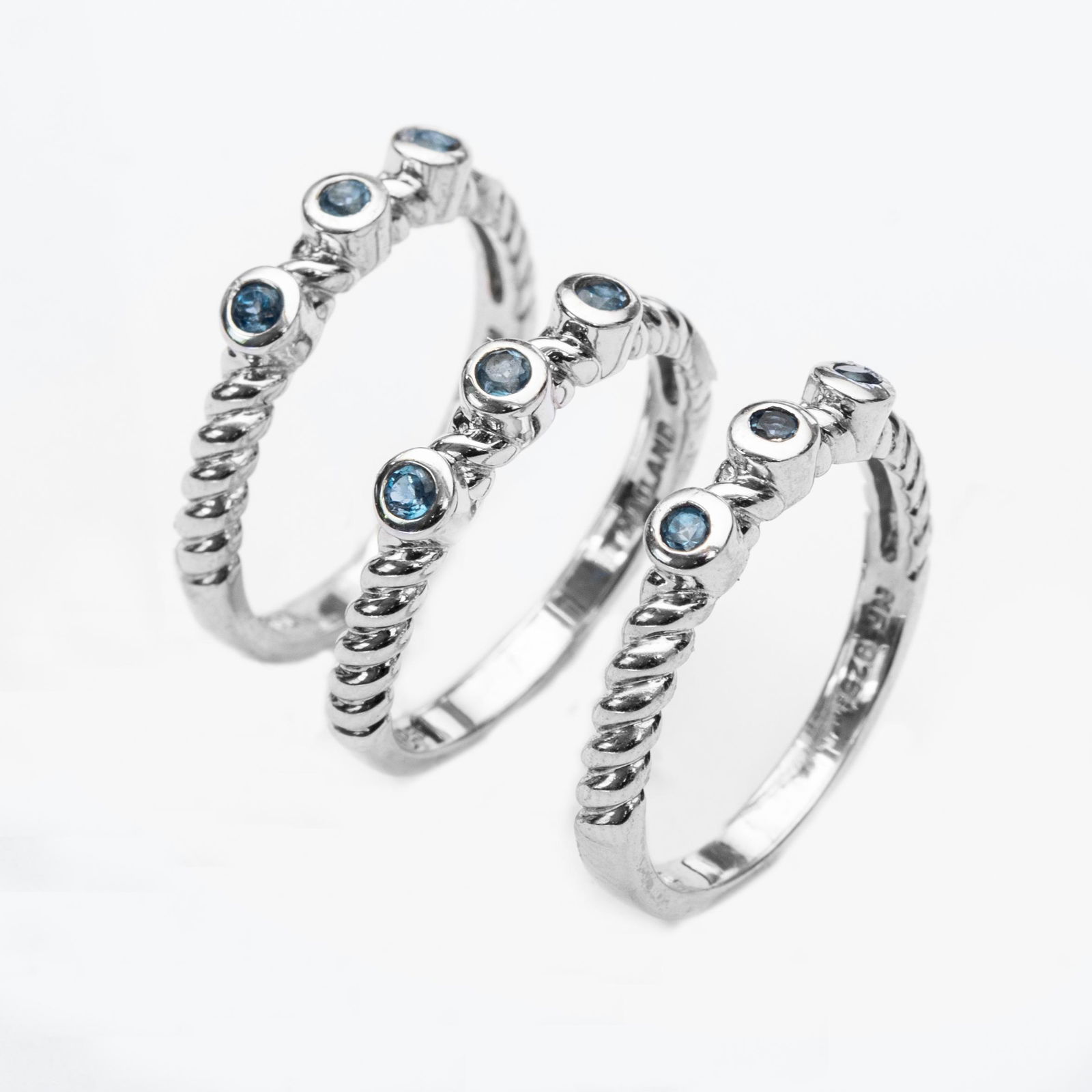 Silver London Blue Topaz Stackable Rings-SZ 7: • Genuine london blue topaz • Setting: Bezel/ Adhesive • Measurement: 9mm L x 20mm W x 4mm H • Stackable with rope design • Gleaming rhodium over fine sterling silver