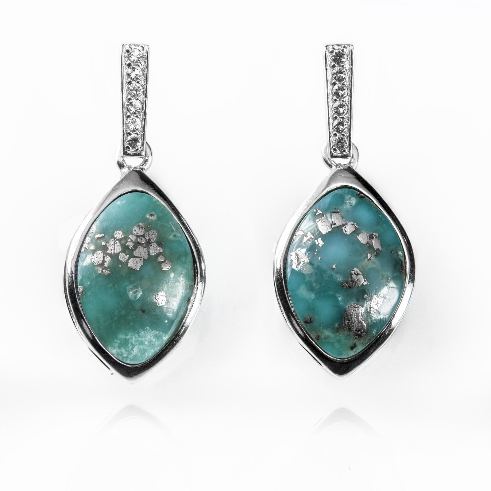Silver Campo Frio Turquoise & Topaz Earrings: • Genuine campo frio turquoise & white topaz • Setting: Bezel/ Adhesive • Measurement: 1-35mm L x 14mm W x 8mm H • Comfortable butterfly clasp • Gleaming rhodium over fin