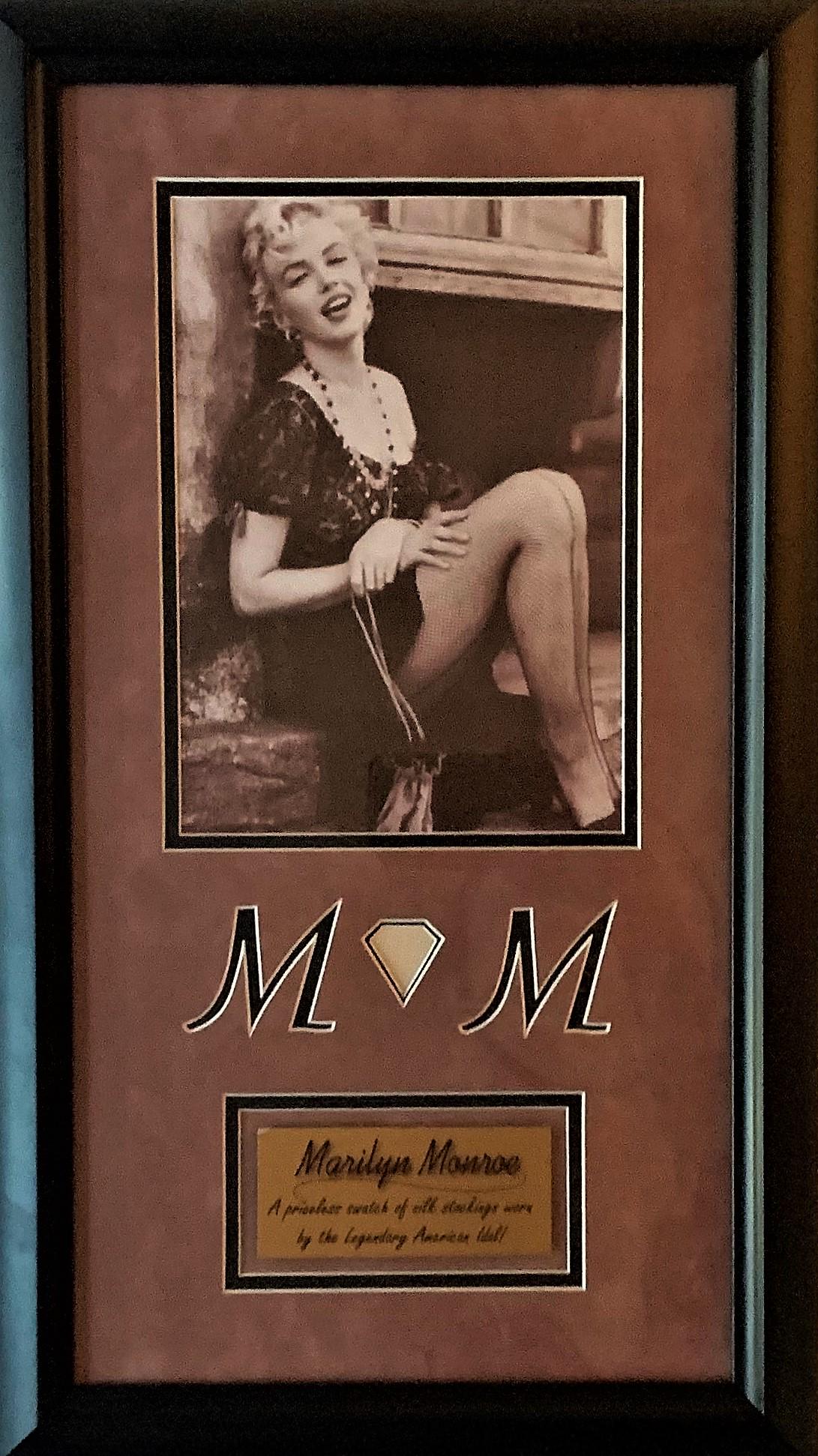 Marilyn Monroe Swatch Silk Stocking Worn: Marilyn Monroe (June 1, 1926-August 4, 1962). A Swatch of Silk Stockings worn by Marilyn Monroe. Matted and Framed with a 7 x 9 ½ Black and White Photograph of Marilyn Monroe. With an overall siz