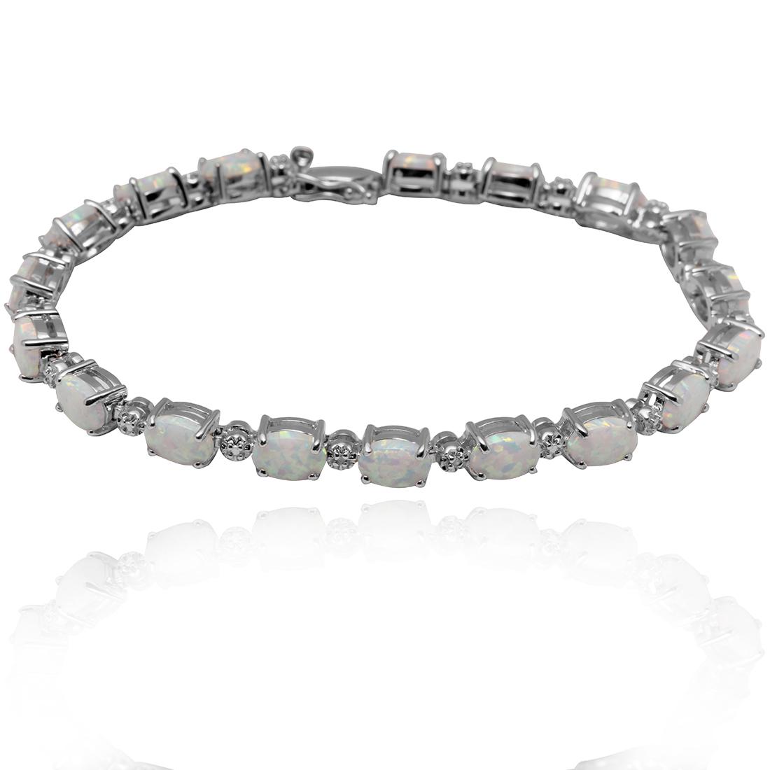 Created Opal Sterling Silver Tennis Bracelet: Created Fire Opal Sterling Silver Tennis Bracelet• Metal: Sterling Silver• Stone: Created Opal • Total Weight: 11.5 grams• Finish: Rhodium• Length: 7.5 inches • Clo