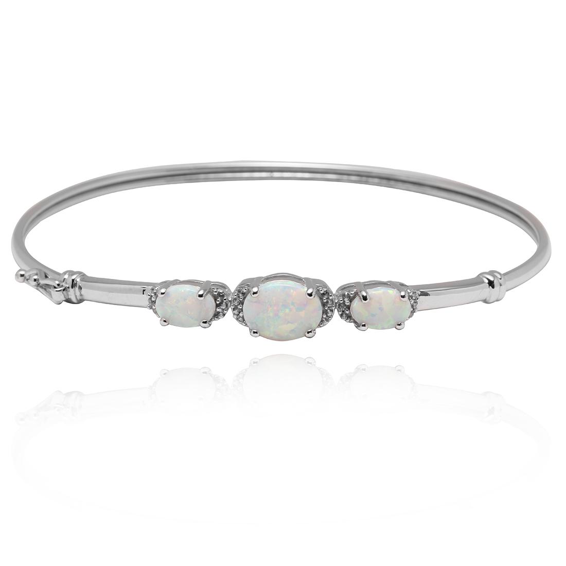 Sterling Silver Three Stones Opal Bangle: Sterling Silver Three Stones Opal Bangle Bracelet • Metal: Sterling Silver• Stone: Created Opal,CZ • Total Weight: 5.8 grams• Finish: Rhodium• Length: 7 inches • Cl
