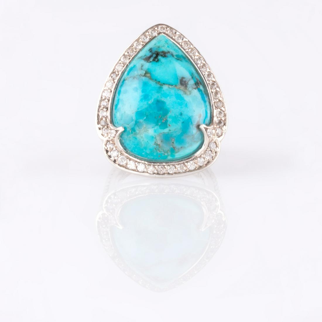 Silver Turquoise & White Zircon Halo Ring-SZ 8: Metal: Sterling SilverStone Information:Gemstone Choice: One pear shaped 23 x 17mm compressed and stabilized Kingman turquoise cabochonWhite Zircon: Various round modified-brilliant cut 1.2-1.5mmSetti