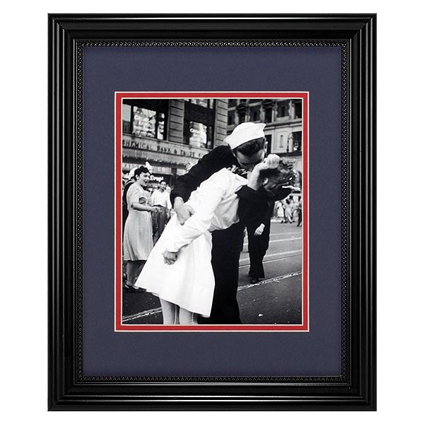 V-J Day Kiss In Time Square Framed: V-J Day in Times Square is a photograph by Alfred Eisenstaedt that portrays an American sailor kissing a young nurse in a white dress on V-J Day in Times Square on August 14, 1945. The photograph was