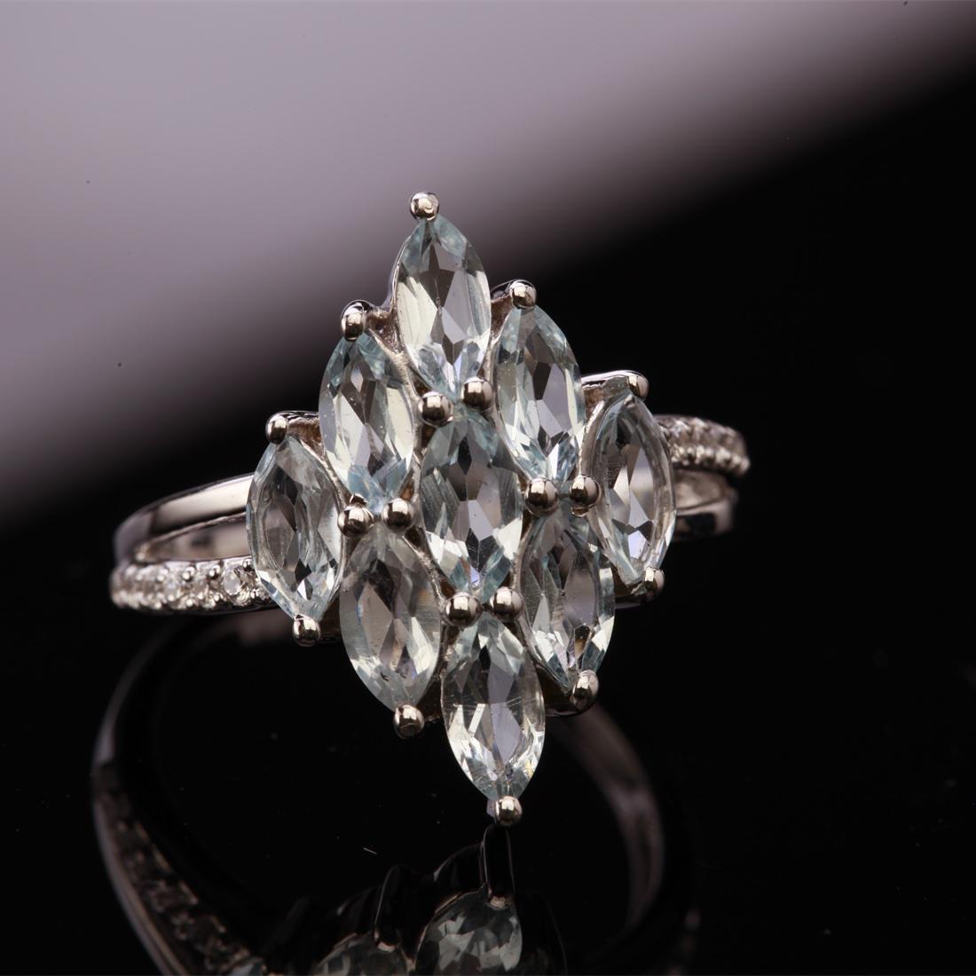 Size 9 Sterling Marquise Blue Topaz &Zircon Ring: Size 9 Sterling Marquise Blue Topaz &Zircon Ring • Metal: Sterling Silver • Stone: Sky Blue Topaz &White Zircon • Width: 20 Mm • Total Weight: 3.48Grs • Finish: Rhodium