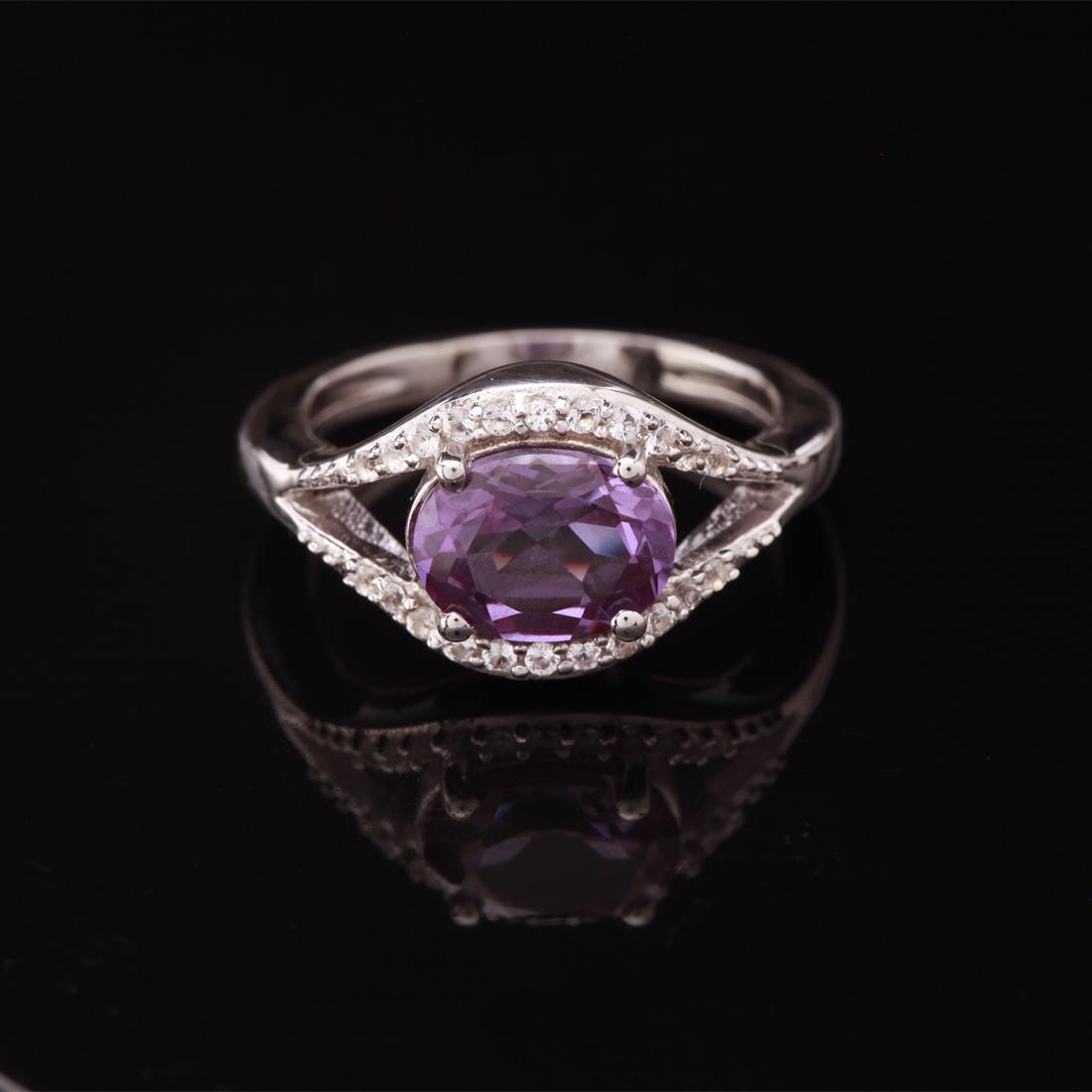 Size 8 Sterling Slv Syn Alexandrite & Topaz Ring: Size 8 Sterling Slv Syn Alexandrite & Topaz Ring • Metal: Sterling Silver • Stone: Syn Alexandrite&White Topaz • Width: 11 Mm • Total Weight: 4.05 Grs • Finish: Rhodium