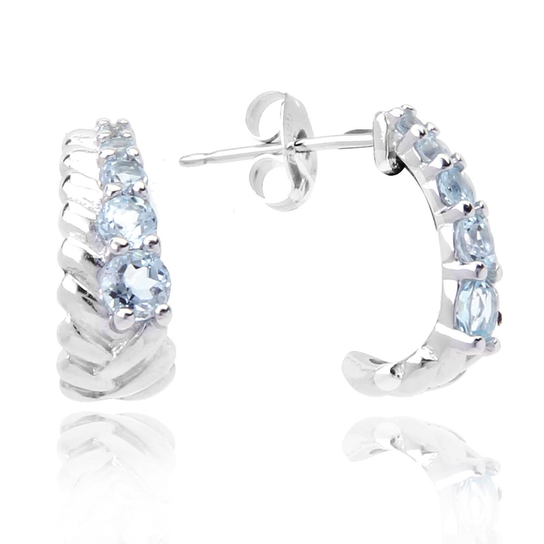 Sterling Silver Blue Topaz Hoop Earrings: Sterling Silver Blue Topaz Hoop Earrings • Metal: Sterling Silver • Stone: Blue Topaz • Dimensions: 14.7 X 6.16 mm • Total Weight: 2.44grams • Backing: Butterfly • 