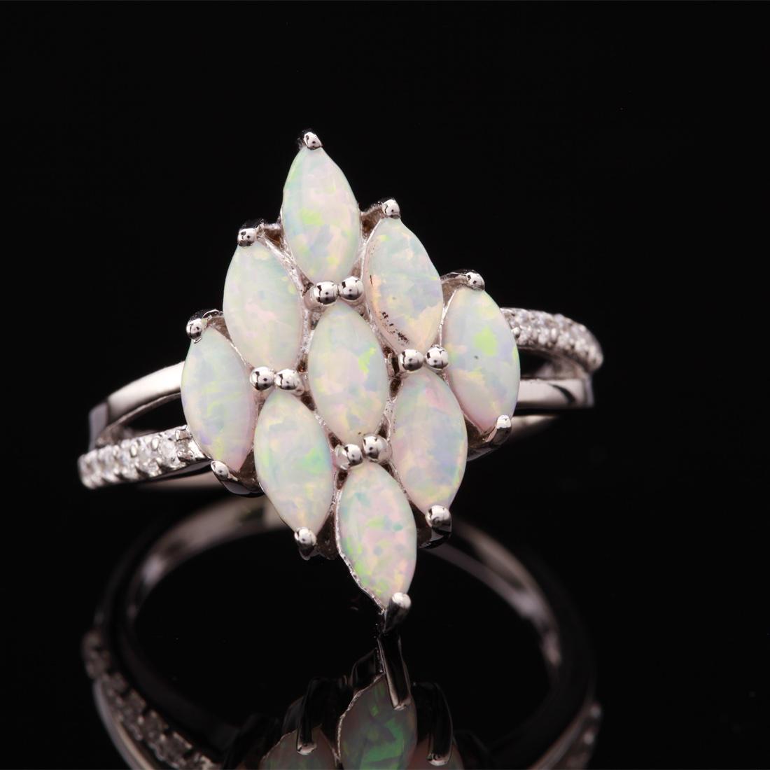 Size 6.25 Sterling Silver Marquise Syn Opal Ring: Size 6.25 Sterling Silver Marquise Syn Opal Ring • Metal: Sterling Silver • Stone: Syn White Opal & White Zircon • Dimensions: 12.7X19.1 Mm • Total Weight: 3.25 Grs • Fin