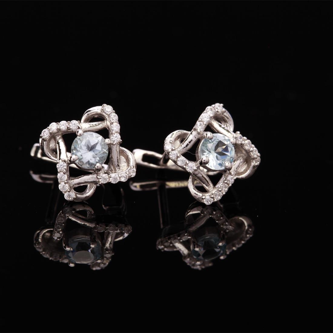 Sterling Silver Blue Topaz Latch Back Earrings: Sterling Silver Blue Topaz Latch Back Earrings • Metal: Sterling Silver • Stone: (2)5Mm-Sky Blue Topaz &White Zircon • Dimensions: 14.06X14.36 Mm • Total Weight: 3.93Grs •