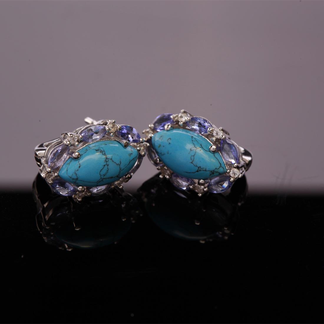 Sterling Silver Tanzanite & Syn Turquoise Earrings: Sterling Silver Tanzanite & Syn Turquoise Earrings • Metal: Sterling Silver • Stone: (2)14X7Mm-Syn Tourquoise &Tanzanite & White Topaz • Dimensions: 11.8X18.4 Mm • Total Weight