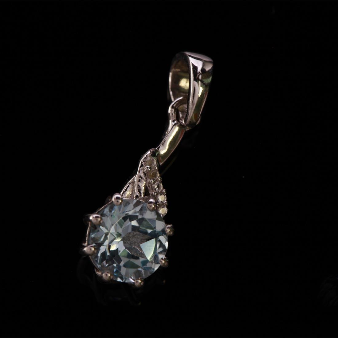 Sterling Silver Sky Blue Topaz & Zircon Pendant: Sterling Silver Sky Blue Topaz & Zircon Pendant • Metal: Sterling Silver • Stone: (1)8Mm-Sky Blue Topaz & White Zircon • Dimensions: 26.5X9.5 Mm • Total Weight: 2Grs • Fi