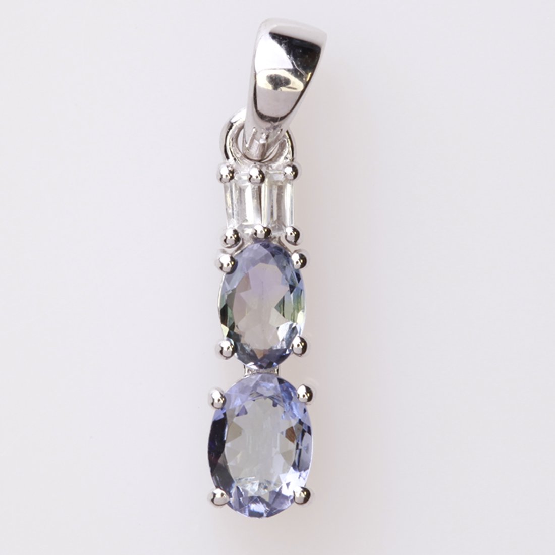 Sterling Silver Bio Tanzanite & Zircon Pendant: Sterling Silver Bio Tanzanite & Zircon Pendant • Metal: Sterling Silver • Stone: Bio Tanzanite&White Zircon • Dimensions: 5.1X24.8 Mm • Total Weight: 1.62 Grs • Finish: Rhodiu
