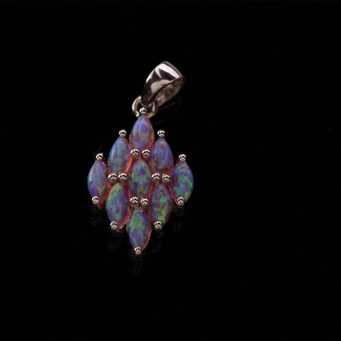 Irisdescent Syn Pink Opal Sterling Silver Pendant: Irisdescent Syn Pink Opal Sterling Silver Pendant • Metal: Sterling Silver • Stone: Syn Pink Opal • Dimensions: 27.22X13.27 Mm • Total Weight: 2.21 Grs • Finish: Rhodium