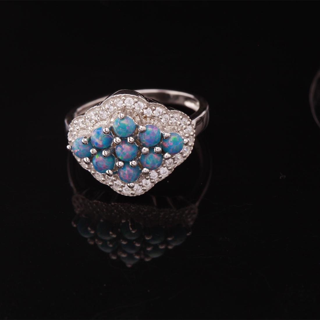 Sz 7.5 Sterling Slv Syn Marine Opal & Zircon Ring: Sz 7.5 Sterling Slv Syn Marine Opal & Zircon Ring • Metal: Sterling Silver • Stone: Syn Marine Opal&White Zircon • Width: 14.3 Mm • Total Weight: 3.85 Grs • Finish: Rhodi