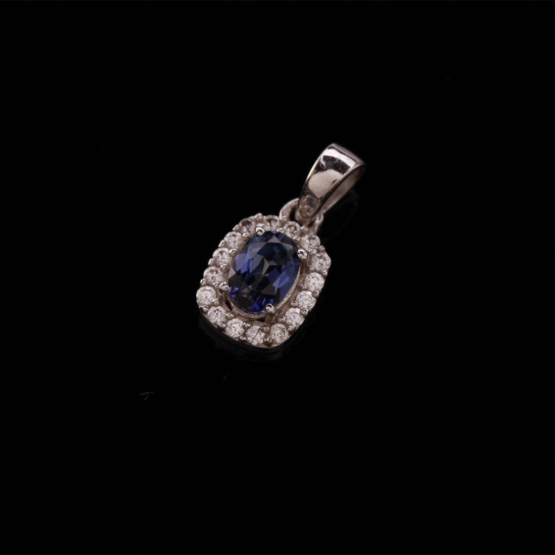 Sterling Silver Iolite & Zircon Halo Pendant: Sterling Silver Iolite & Zircon Halo Pendant • Metal: Sterling Silver • Stone: (1)7X5Mm-Iolite&White Zircon • Dimensions: 18.17X8.81 Mm • Total Weight: 1.39Grs • Finish: