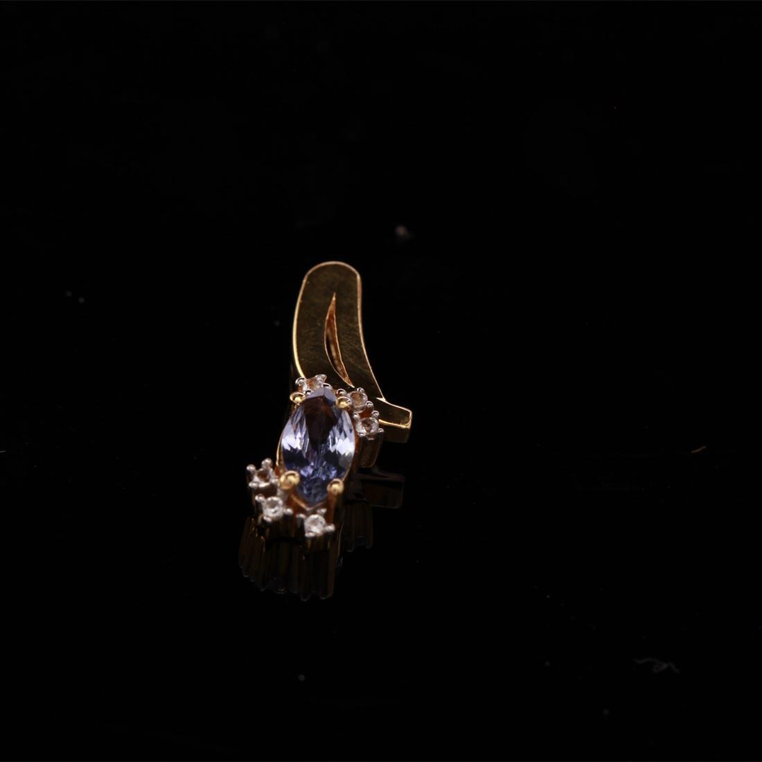14K Over Sterling Silver Tanzanite Pendant: 14K Over Sterling Silver Tanzanite Pendant • Metal: Sterling Silver • Stone: (1)8X4Mm-Tanzanite & White Topaz • Dimensions: 27.6X19 Mm • Total Weight: 1.51Grs • Finish: 1