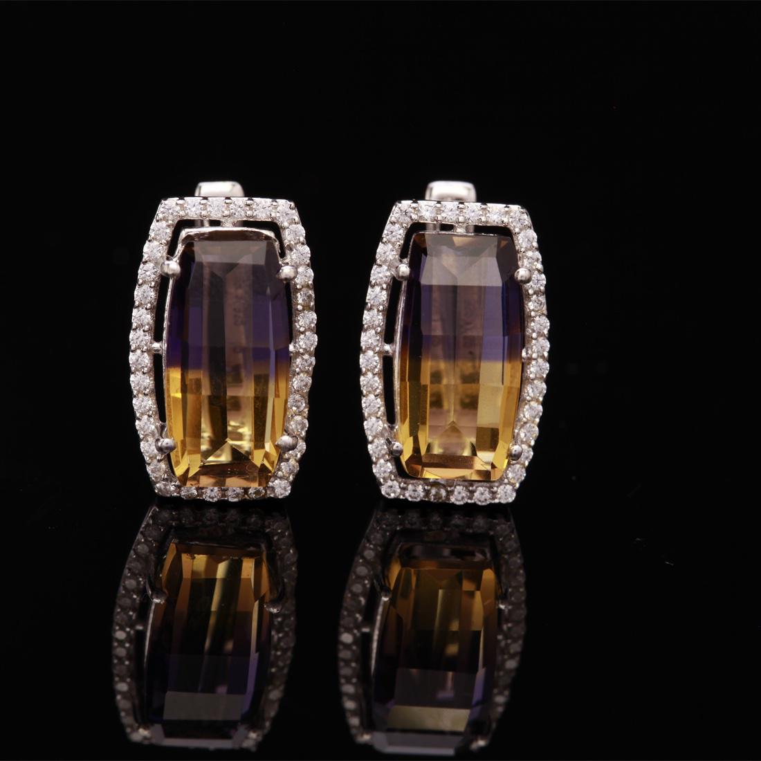 Bicolor Nano Ametrine & Zircon Lacth Back Earrings: Bicolor Nano Ametrine & Zircon Lacth Back Earrings • Metal: Sterling Silver • Stone: (2)14X7Mm-Nano Ametrine&White Zircon • Dimensions: 17.69X10.88 Mm • Total Weight: 6.15 Grs 