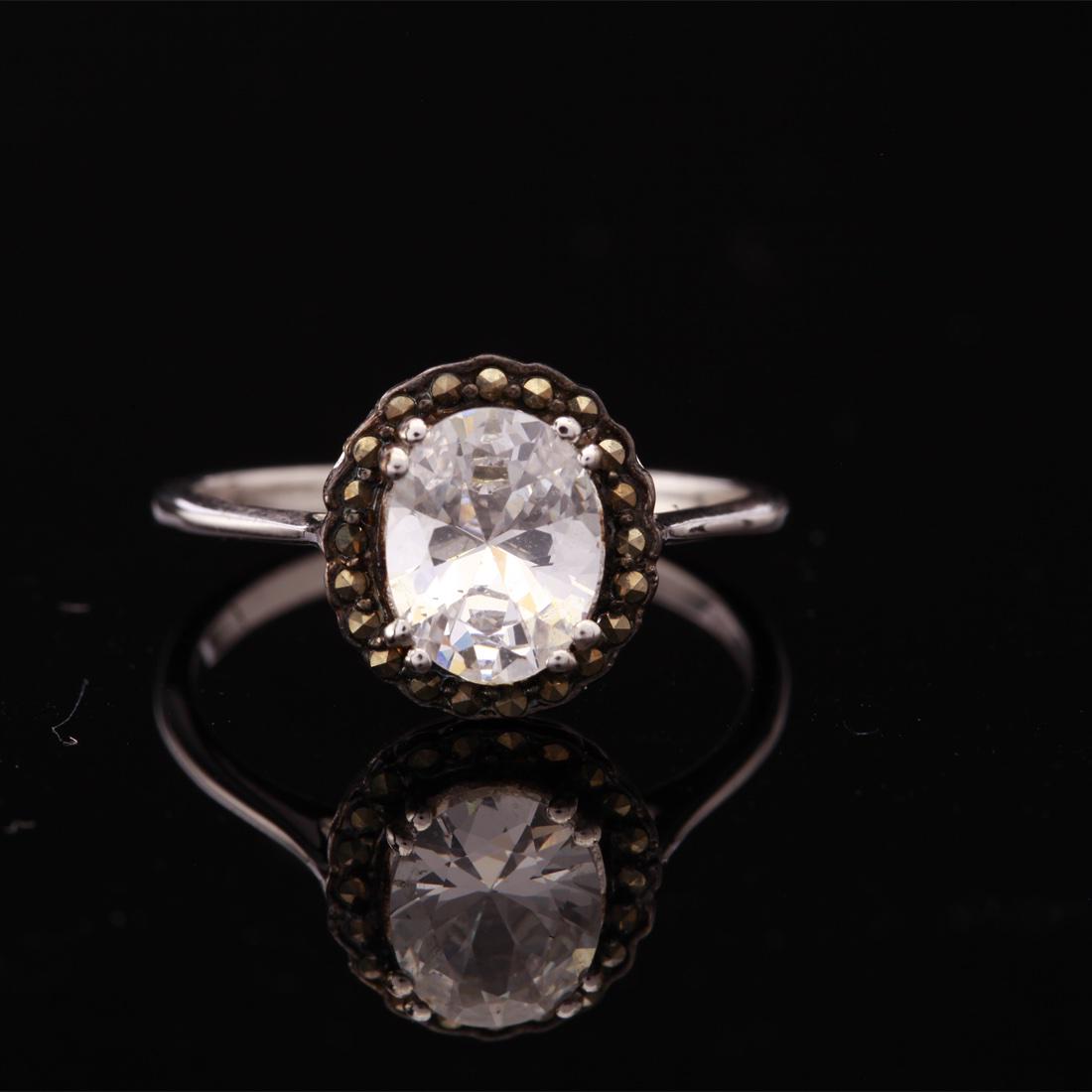 Sterling White Zircon & Marcasite Halo Ring Sz 9: Size 9 Sterling White Zircon Marcasite Ring • Metal: Sterling Silver • Stone: (1) 9X7 Mm White Zircon Marcasite • Width: 12 Mm • Total Weight: 2.9 Grs • Finish: Rhodium