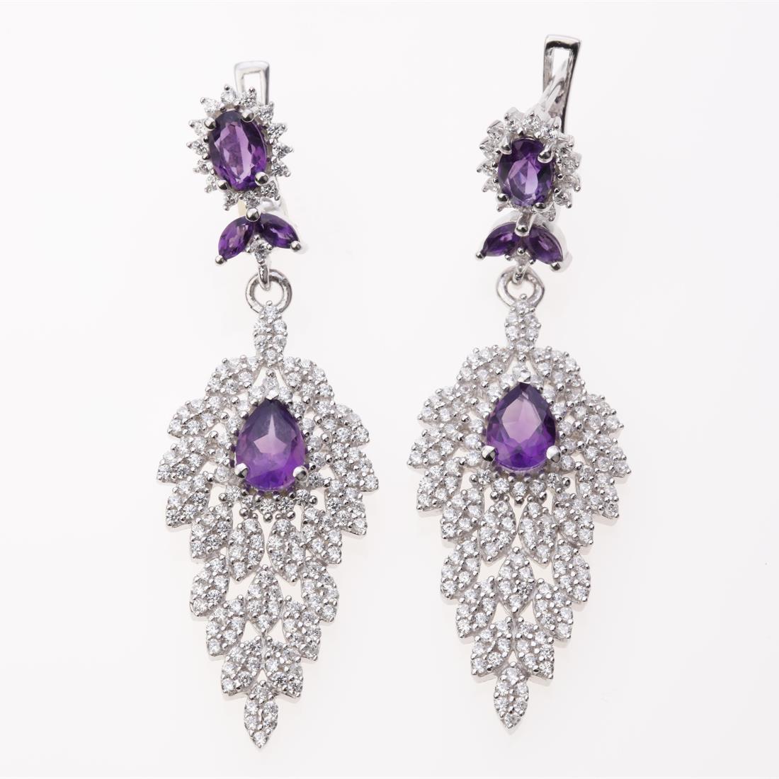 African Amethyst & Zircon Dangle Silver Earrings: African Amethyst & Zircon Dangle Silver Earrings .Metal: Sterling Silver .Stone: 7X5 Mm Pr African Amethyst & White Zircon .Dimension: 51.6X16.6Mm .Total Weight: 10.58 Grams .Finish: Rhodium .Backing: