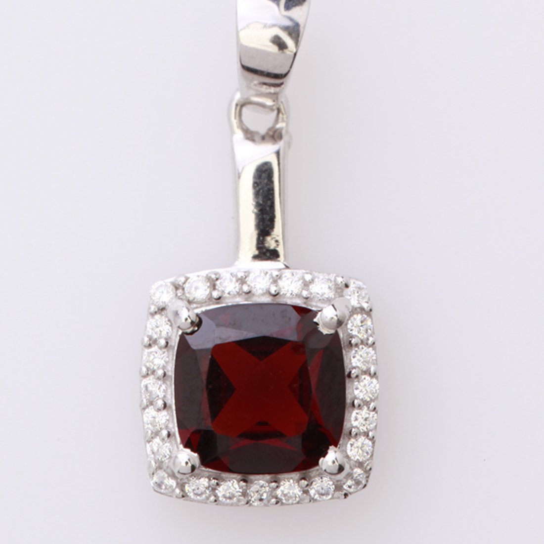 Cushion Cut Garnet & Zircon Sterling Slv Pendant: Cushion Cut Garnet & Zircon Sterling Slv Pendant • Metal: Sterling Silver • Stone: (1)8X8Mm-Garnet&White Zircon • Dimensions: 25.24X11.18 Mm • Total Weight: 2.18Grs • Finish: 