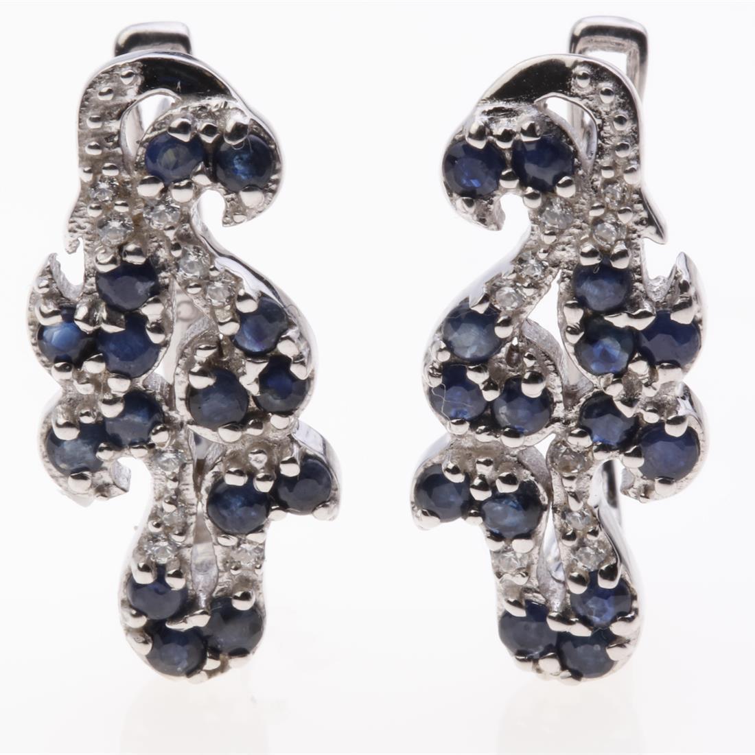 Sapphire & Zircon Silver Scroll Earrings: Sapphire & Zircon Silver Scroll Earrings .Metal: Sterling Silver .Stone: 2 Mm Rd Blue Sapphire&Zircon .Dimension: 21.6X10Mm .Total Weight: 5.73 Grams .Finish: Rhodium .Backing: French Clip