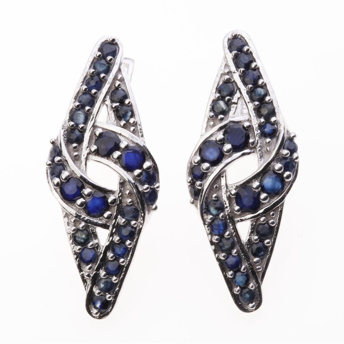 Contemporary Sapphire & Zircon Latchback Earrings: Contemporary Sapphire & Zircon Latchback Earrings .Metal: Sterling Silver .Stone: 3 Mm Rd Blue Sapphire&Zircon .Dimension: 32.4X13.3Mm .Total Weight: 9.13 Grams .Finish: Rhodium .Backing: Latchback