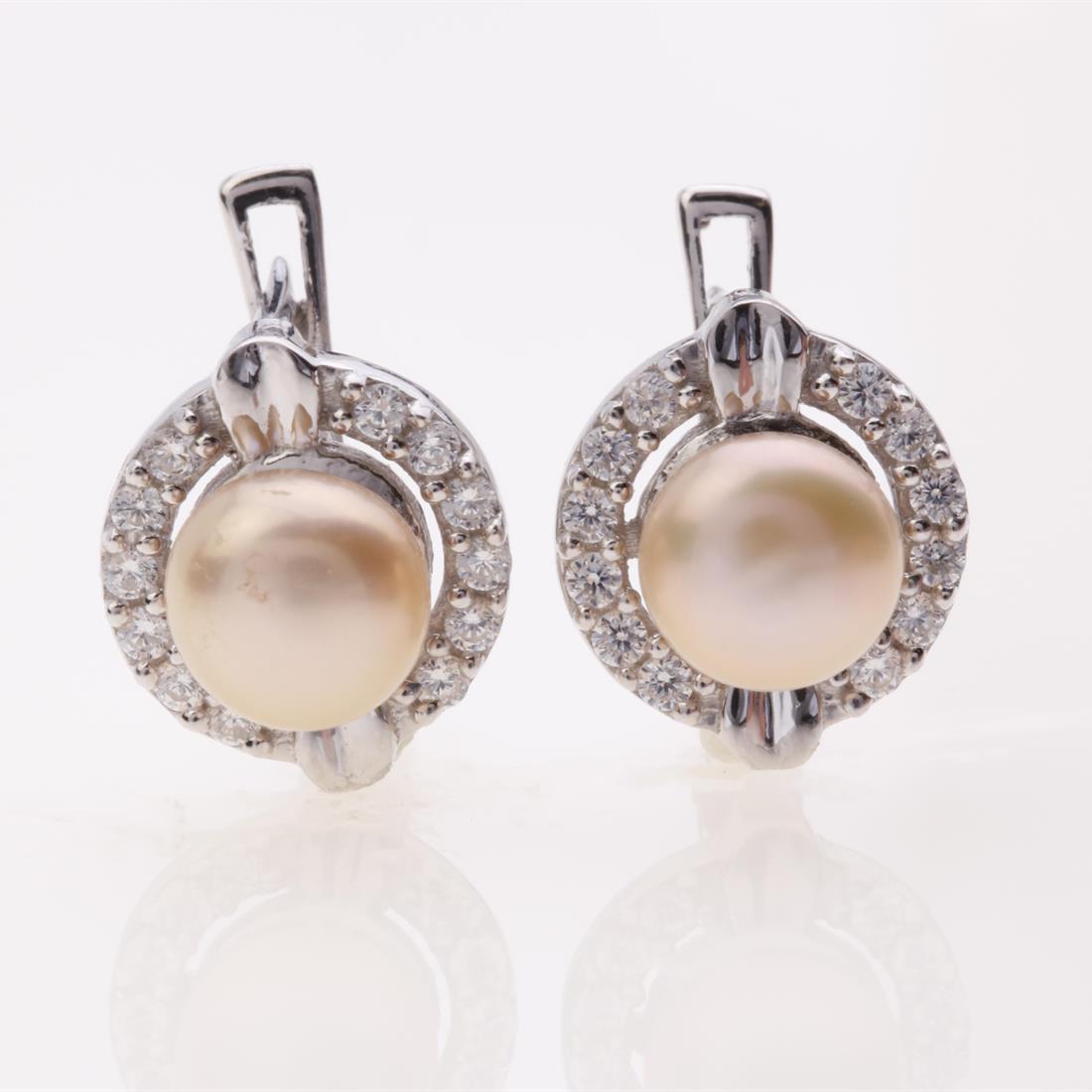 Pearl & Zircon Halo Sterling Silver Earrings: Pearl & Zircon Halo Sterling Silver Earrings .Metal: Sterling Silver .Stone: Ivory Pearl&Zircon .Dimension: 12.7X11Mm .Total Weight: 4.75 Grams .Finish: Rhodium .Backing: French Clip