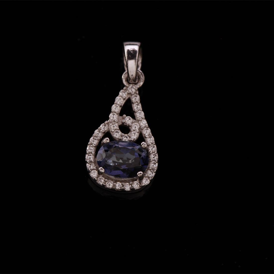 Sterling Silver Radiant Iolite & Zircon Pendant: Sterling Silver Radiant Iolite & Zircon Pendant • Metal: Sterling Silver • Stone: (1)8X6Mm-Iolite&White Zircon • Dimensions: 26.7X11.32 Mm • Total Weight: 2.08Grs • Finis