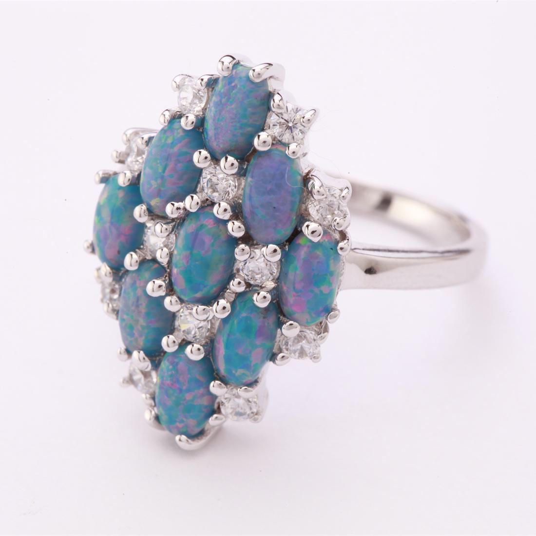 Size7.75 Sterling Syn Marine Opal & Zircon Ring: Size7.75 Sterling Syn Marine Opal & Zircon Ring • Metal: Sterling Silver • Stone: Syn Marine Opal & White Zircon • Width: 19.9 Mm • Total Weight: 4.12 Grs • Finish: Rhodi