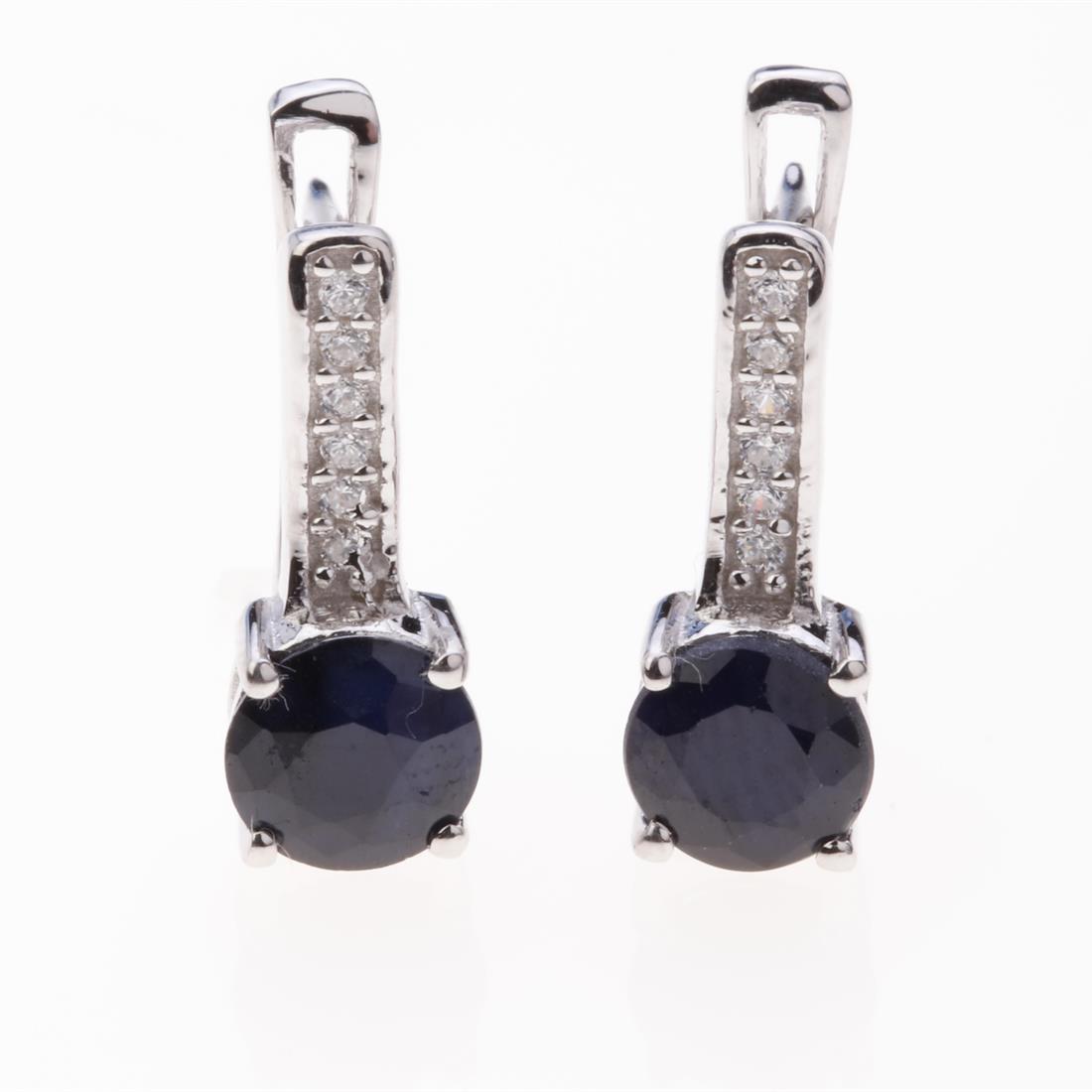 Sapphire & Zircon Latchback Silver Earrings: Sapphire & Zircon Latchback Silver Earrings .Metal: Sterling Silver .Stone: 6 Mm Rd Blue Sapphire&White Zircon .Dimension: 15.5X6.16 Mm .Total Weight: 3.07 Grams .Finish: Rhodium .Backing: Latchback
