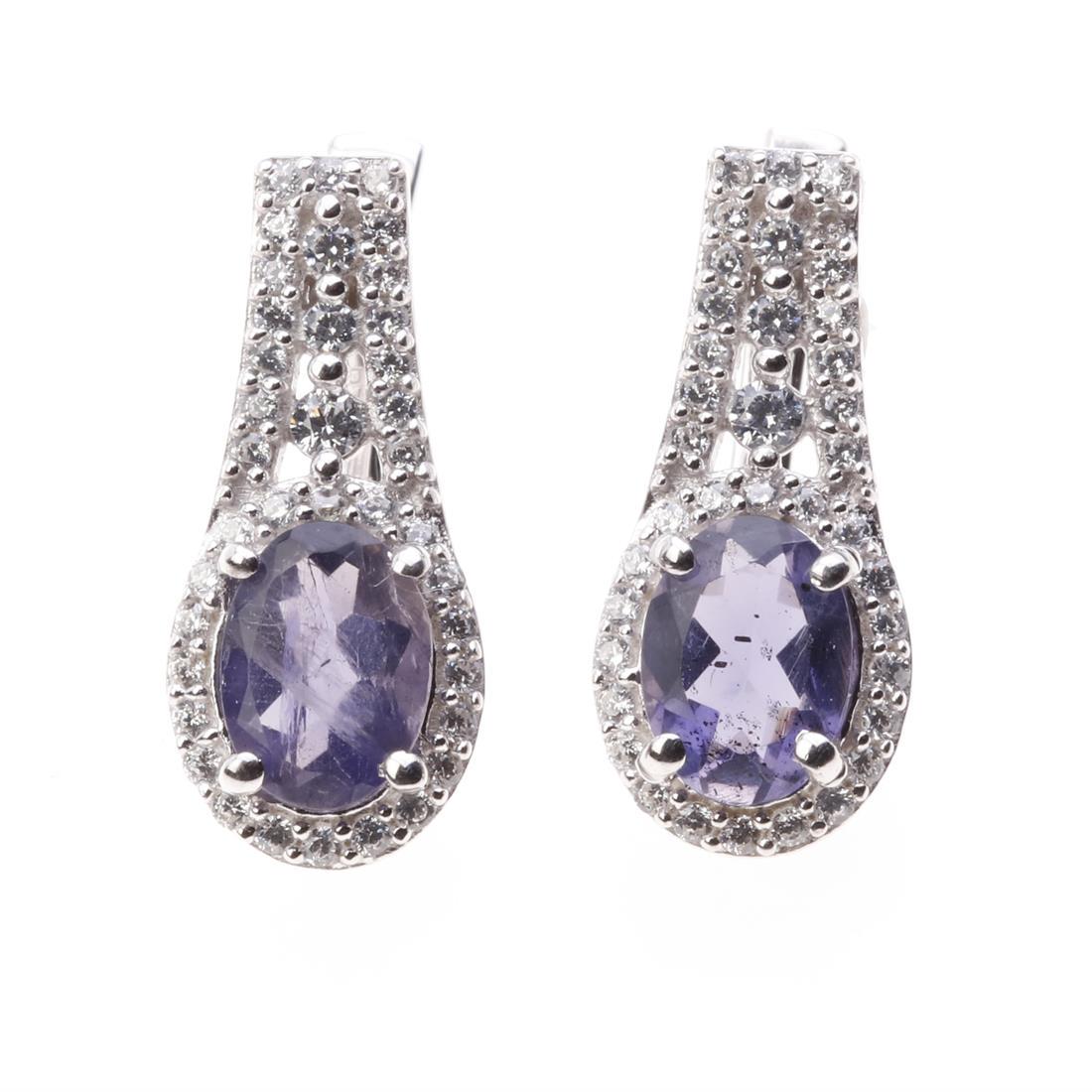 Iolite & Zircon Sterling Silver Earrings: Iolite & Zircon Sterling Silver Earrings • Metal: Sterling Silver • Stone: 8X6 Mm Oval Shape Iolite&White Zircon • Dimension: 20X9 Mm • Total Weight: 4.6 Grams • Finish: