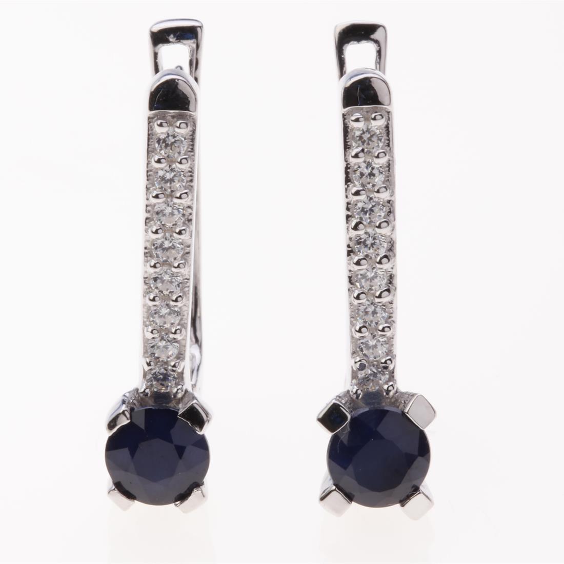 Dark Sapphire & Zircon Latchback Silver Earrings: Dark Sapphire & Zircon Latchback Silver Earrings .Metal: Sterling Silver .Stone: 5 Mm Rd Blue Sapphire&White Zircon .Dimension: 20.9X5.15 Mm .Total Weight: 3.88 Grams .Finish: Rhodium .Backing: Latchb