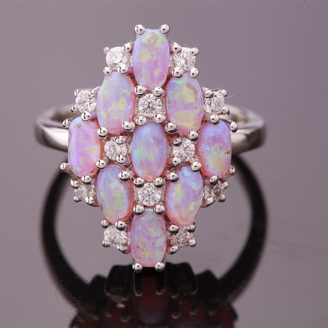 Size 7.75 Sterling Iridescent Syn Pink Opal Ring: Size 7.75 Sterling Iridescent Syn Pink Opal Ring • Metal: Sterling Silver • Stone: Syn Pink Opal & White Zircon • Width: 20.3 Mm • Total Weight: 4.1 Grs • Finish: Rhodium
