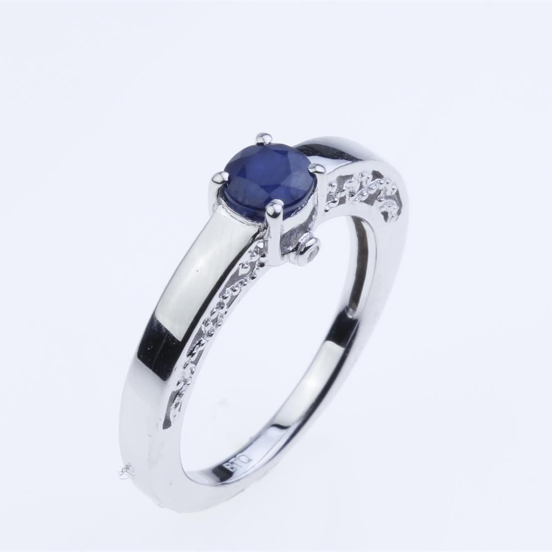 Size 9 Sapphire Sterling Silver Ring: Size 9 Sapphire Sterling Silver Ring • Metal: Sterling Silver • Stone: 5Mm Round Sapphire, Zircon • Width : 6.49 Mm • Appx Weight: 3.42 Grams • Finish: Rhodium