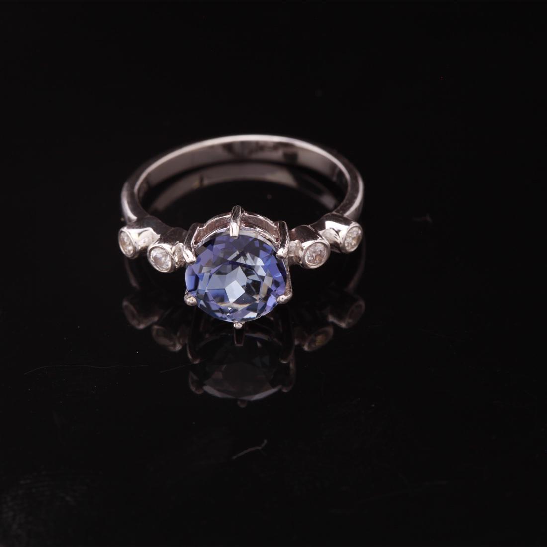 Size 6.5 Sterling Silver Iolite & Zircon Ring: Size 6.5 Sterling Silver Iolite & Zircon Ring • Metal: Sterling Silver • Stone: (1)8Mm-Iolite & White Zircon • Width: 9.1 Mm • Total Weight: 2.44 Grs • Finish: Rhodium