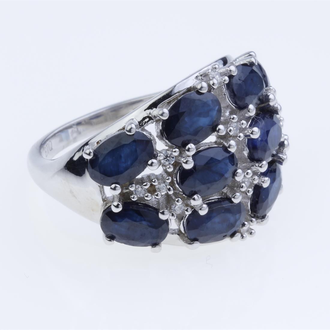 Size 8.5 Blue Sapphire & Zircon Sterling Slv Ring: Size 8.5 Blue Sapphire & Zircon Sterling Slv Ring • Metal: Sterling Silver • Stone: 6X4Mm Sapphire, White Zircon • Width : 16.2 Mm • Appx Weight: 5.71 Grams • Finish: Rho